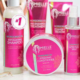 Mielle Organics bottle staged on bathroom shelf for everyday use