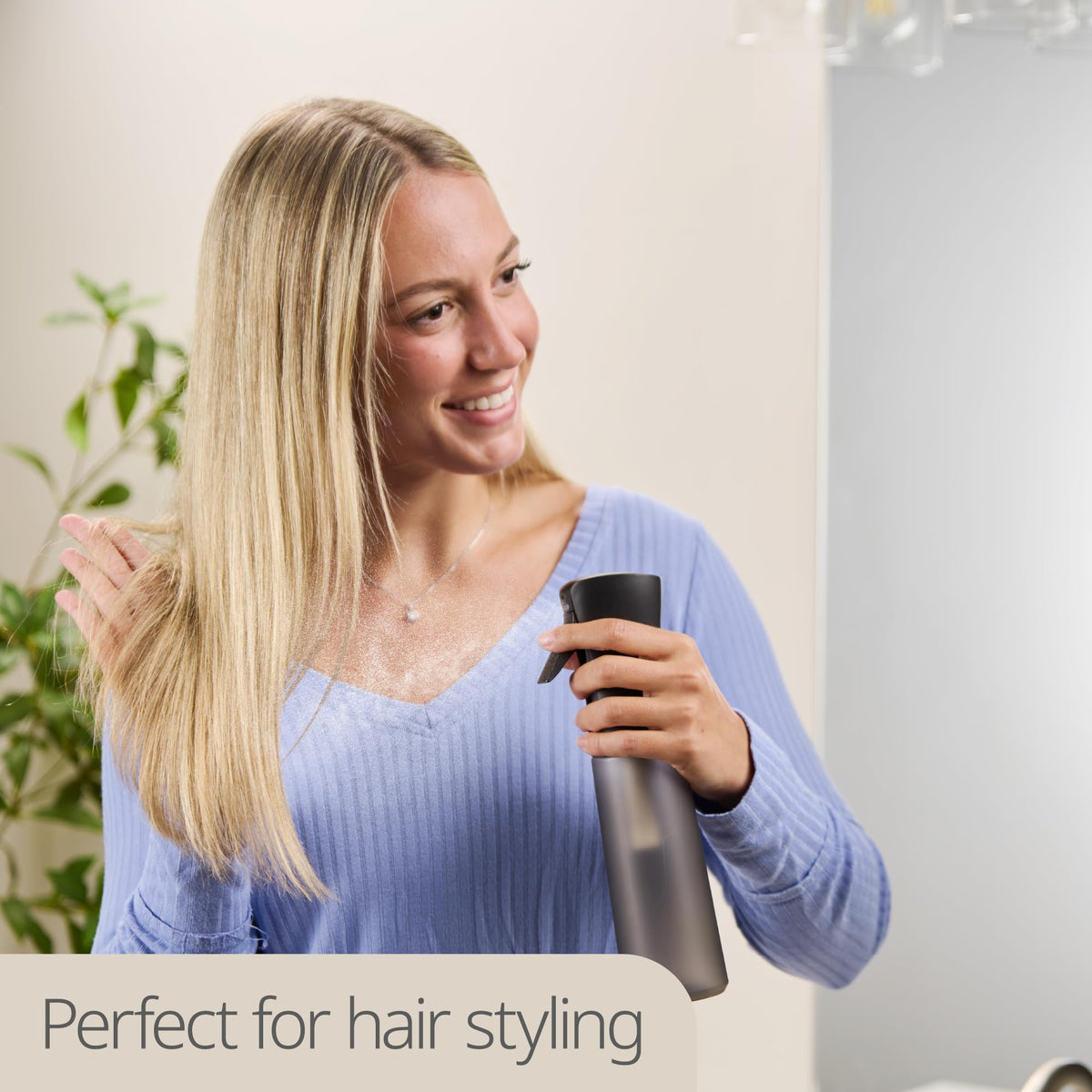 MIGHTY STRONG bottle spraying fine mist on hair for even hydration and styling