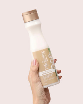 Milagros conditioner creamy texture pouring to smooth and detangle hair