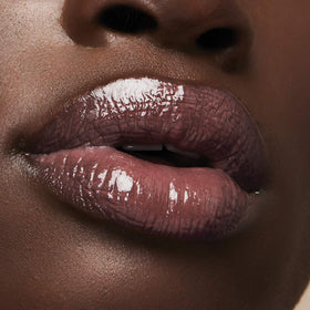 Milani gloss worn by model enhancing lips and complementing makeup