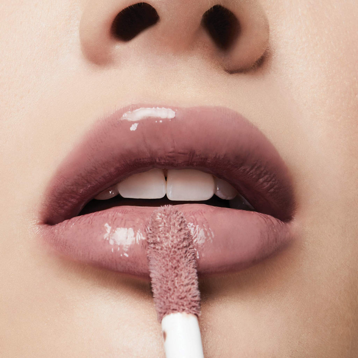 Milani open cap with visible gloss wand highlighting formula consistency