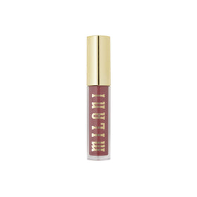 Milani still life with gloss among beauty items showing everyday use