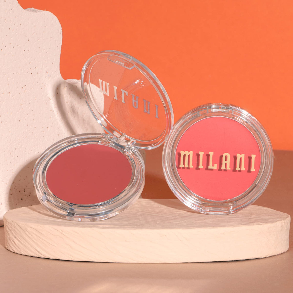 Milani Merlot Moment next to common objects to show true product size and portability
