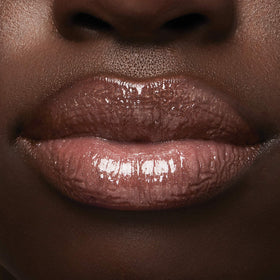 Milani prismatic peach open bottle label detail highlighting ingredients like hyaluronic acid