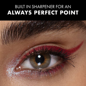 Milani applying eyeliner to upper lash line for defined look