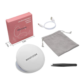 Milishow mirror inside a purse on a travel table showing on-the-go grooming ease