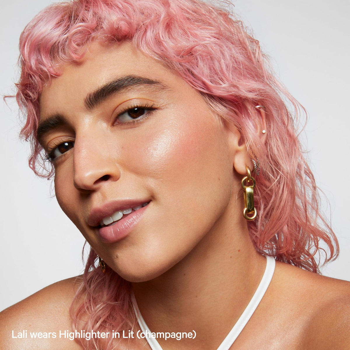 Milk Makeup highlighter applied to cheek showing natural luminous glow for everyday radiance