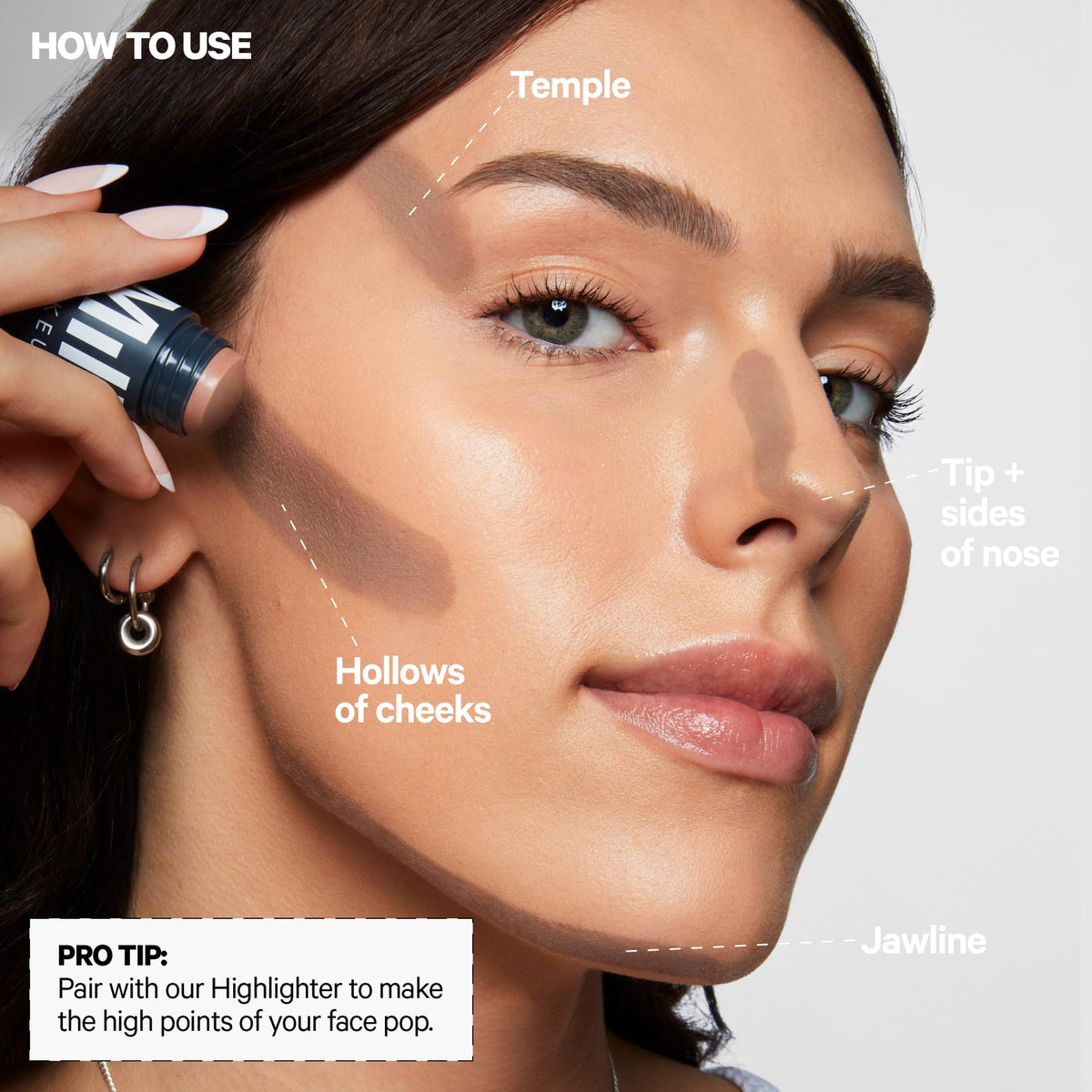 Milk Makeup Sculpt Stick next to hand showing size and portability benefit