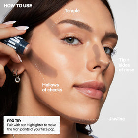 Milk Makeup Sculpt Stick next to hand showing size and portability benefit