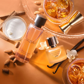 MIX:BAR bottle on bed linens and pillow showing cozy atmosphere benefit: comforting scent