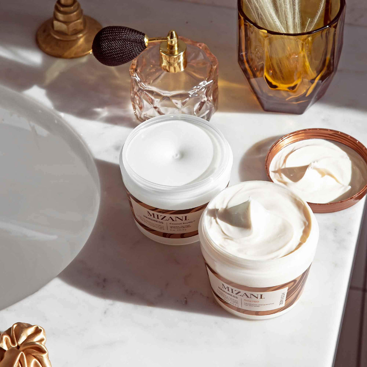 Mizani hand applying soufflé to hair showing quick absorption and softening benefit