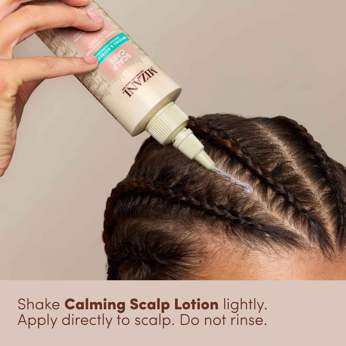 Mizani applying lotion to braided scalp demonstrating soothing relief
