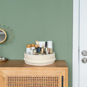 Mkono basket holding perfumes on vanity for tidy easy access