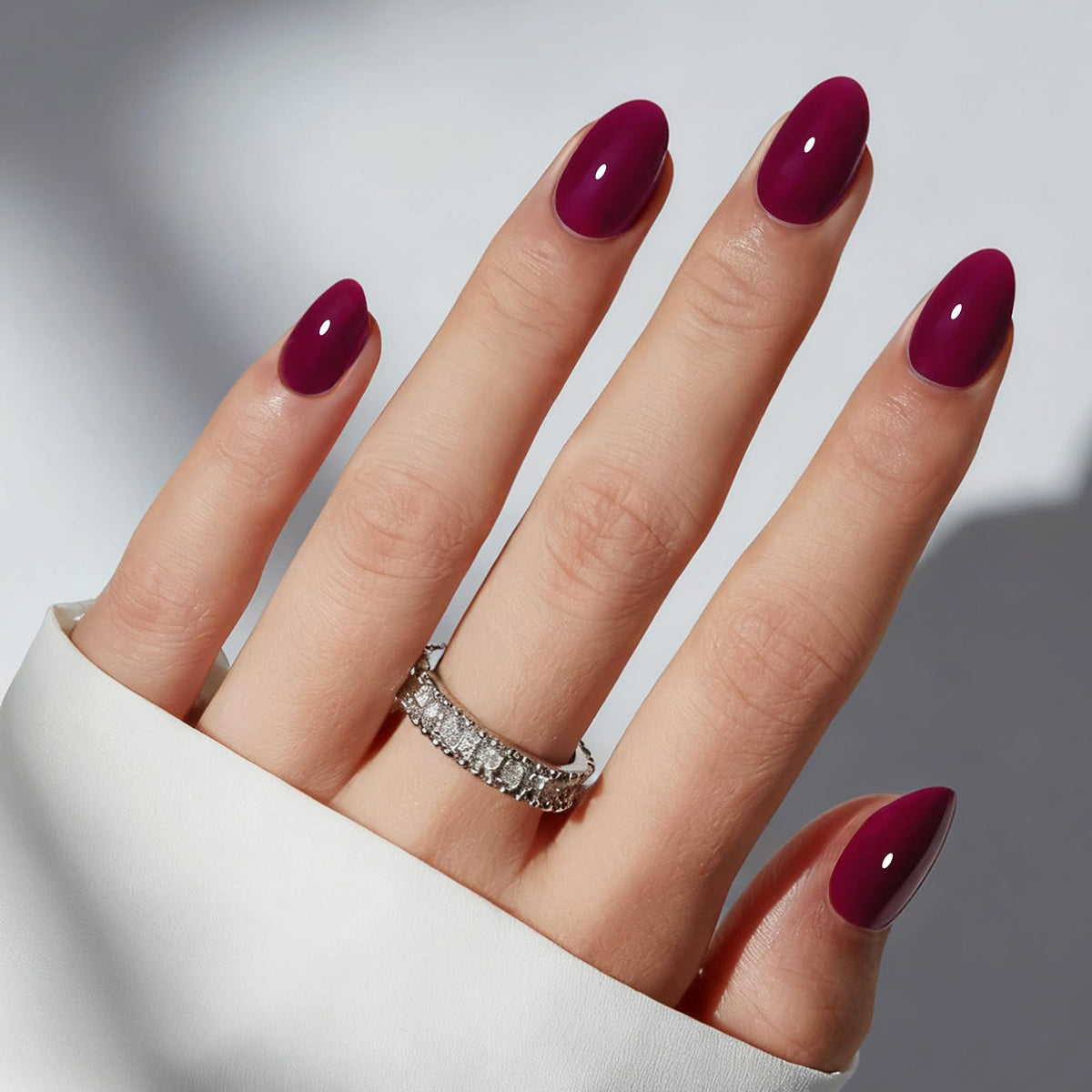 modelones front packaging showing burgundy oval press-on nails and included tools, clear contents benefit