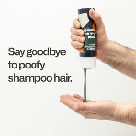 Modern Mammals 8oz bottle beside hand for scale emphasizing portable grooming convenience