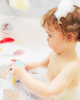 MoHern toddler enjoying bath with sponge easing cleansing and calming routine