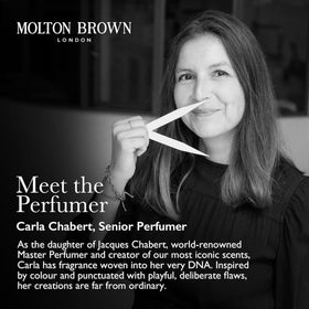 Molton Brown bottle held in hand to show size and travel-friendly convenience benefit