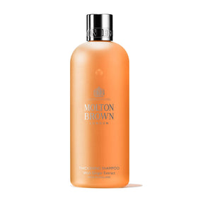 Molton Brown thickening shampoo bottle front view showing label and size, clarifies product use