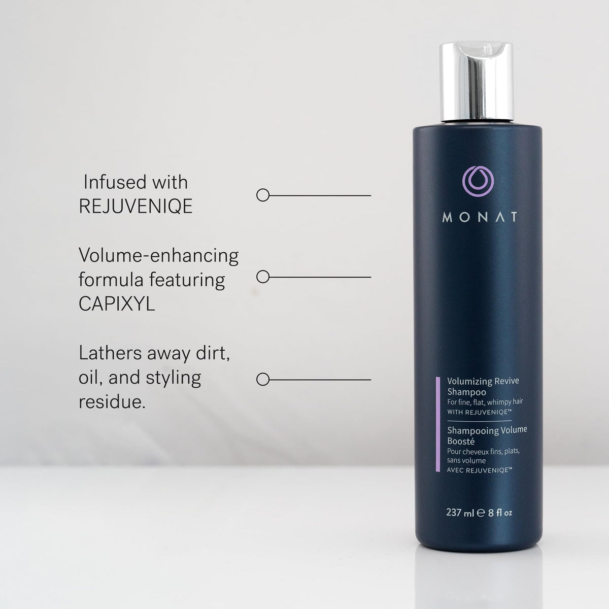 MONAT bottles in hand for size comparison showing travel-friendly ounces