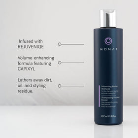 MONAT bottles in hand for size comparison showing travel-friendly ounces