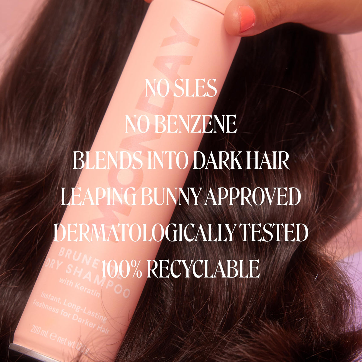 Model applying MONDAY HAIRCARE BRUNETTE to roots to quickly mattify and extend style
