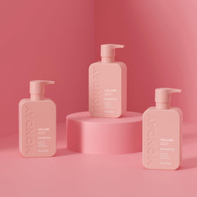 MONDAY HAIRCARE bottle held in hand showing 354 mL size benefit