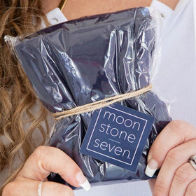 MoonstoneSeven next to towel size comparison highlighting compact, travel friendly design