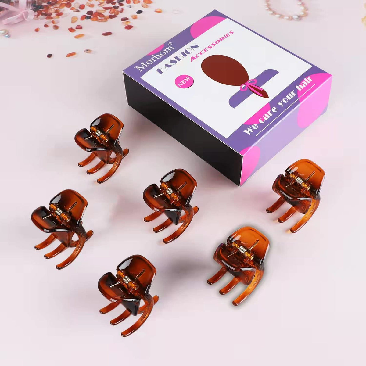 Morhom clips held in hand showing 1.4-inch scale and portable convenience