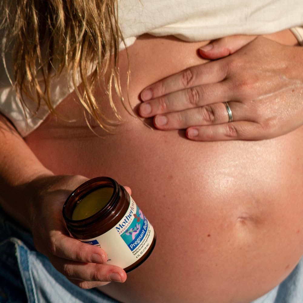 Motherlove salve applied to pregnant belly demonstrating smooth moisturizing benefit