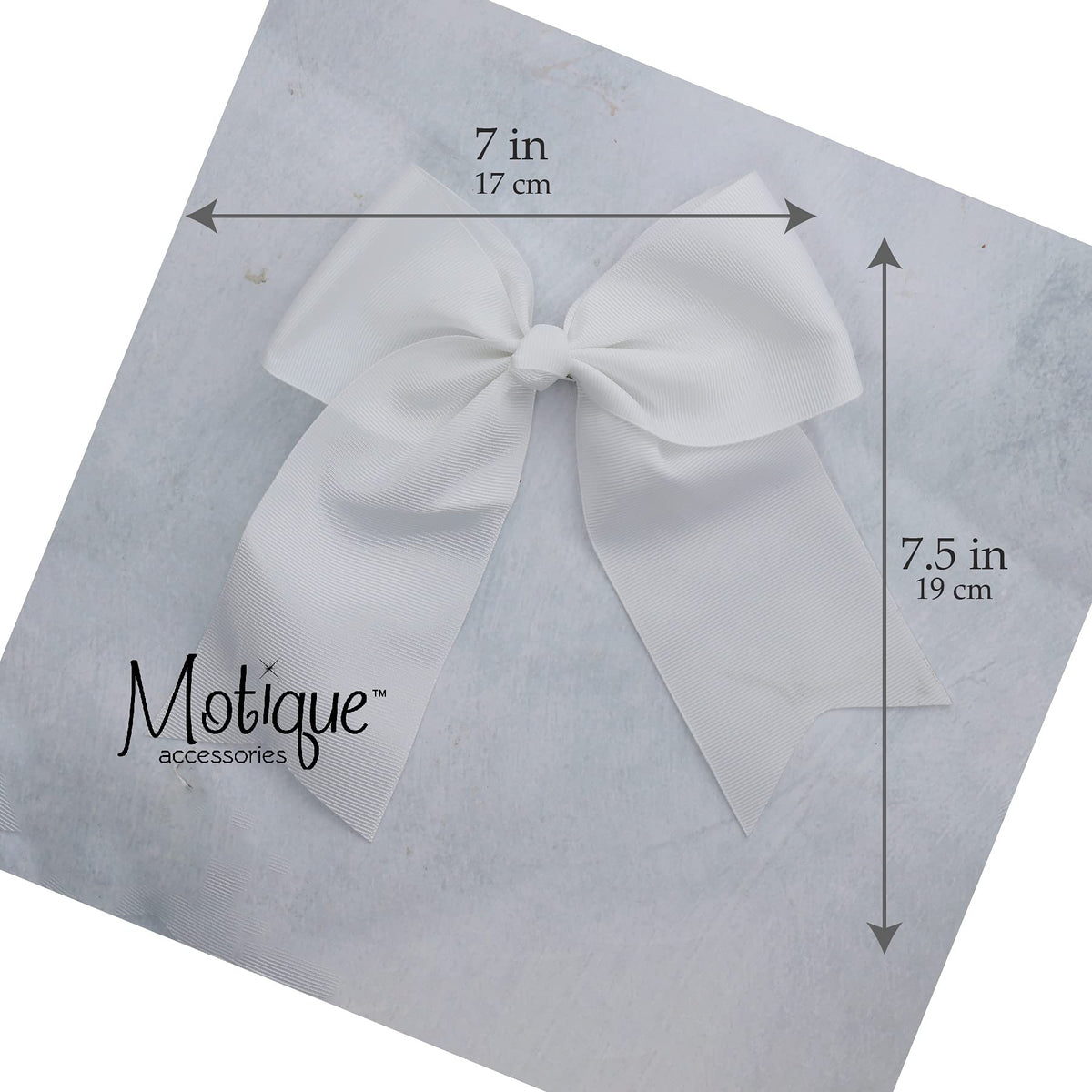 Motique Accessories bow in child's hair lifestyle shot showing playful movement and outfit polish