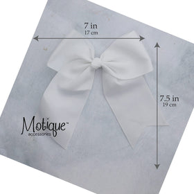 Motique Accessories bow in child's hair lifestyle shot showing playful movement and outfit polish