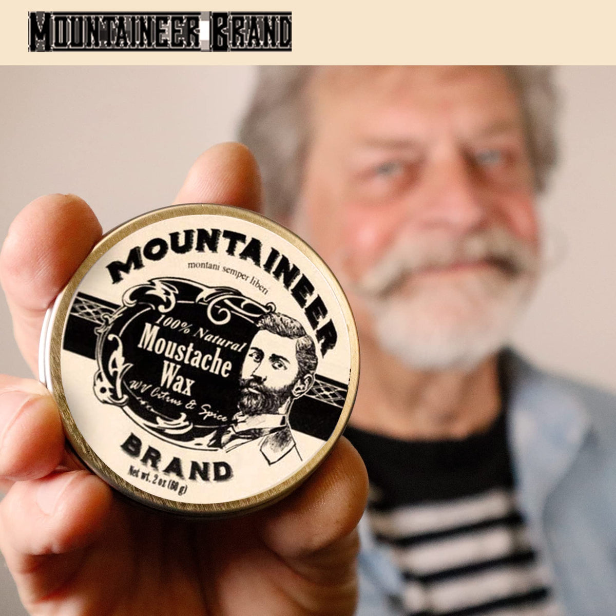 Mountaineer Brand tin held in hand showing 2oz scale for travel-friendly grooming benefit