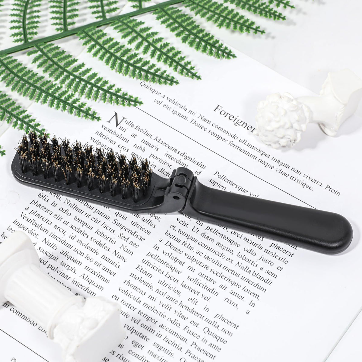 Mozeat Lens unfolded brush held in hand showing full-length grip for quick styling