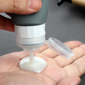 Mrsdry filled bottles on scale confirming TSA-compliant 2oz capacity