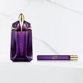 Mugler held in hand to show travel-size scale and easy carry convenience
