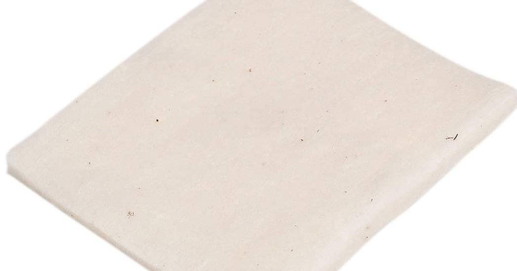 MUJI cotton pad held in hand demonstrating 60x50mm size for controlled application