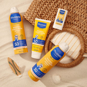 Mustela bottle staged with beach gear for worry-free outings