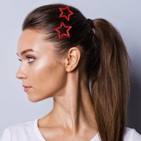 Mxxipp red star clips styled along a braid adding colorful Y2K flair
