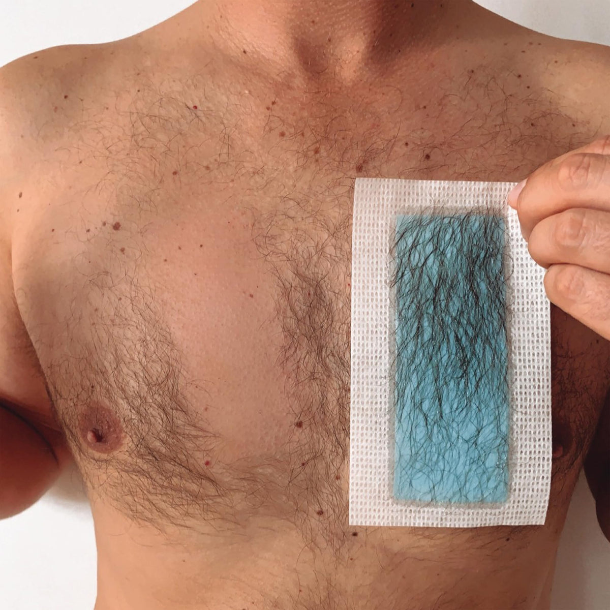 Nad's For Men strip being peeled demonstrating easy hair removal
