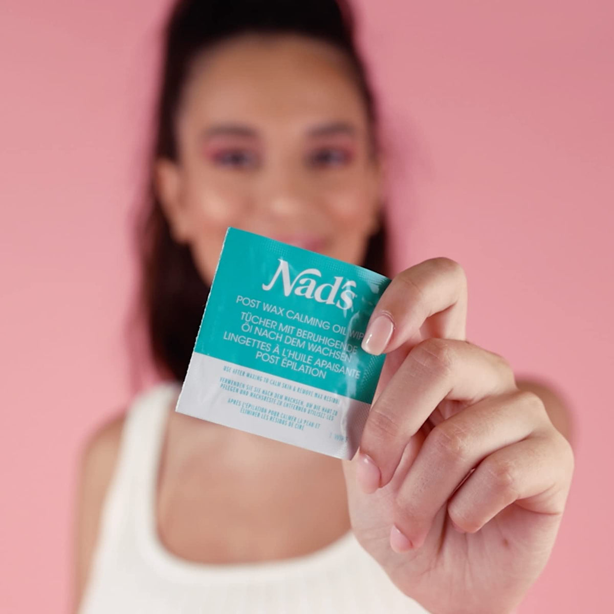 Wipe being used on bikini area to remove residue and soothe skin after waxing with Nad's