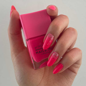 Nails Inc swatch on wrist revealing true neon pink pigment and smooth coverage