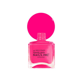 Nails Inc bottle staged with travel items illustrating portable, fast-dry polish