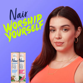 Nair tube held in hand to show compact size for travel convenience