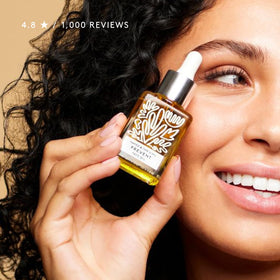 Naked & Thriving bottle on vanity with towel, suggests daily routine ease