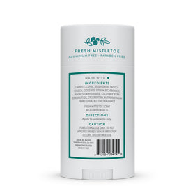 Native deodorant next to a coin illustrating compact size and travel convenience