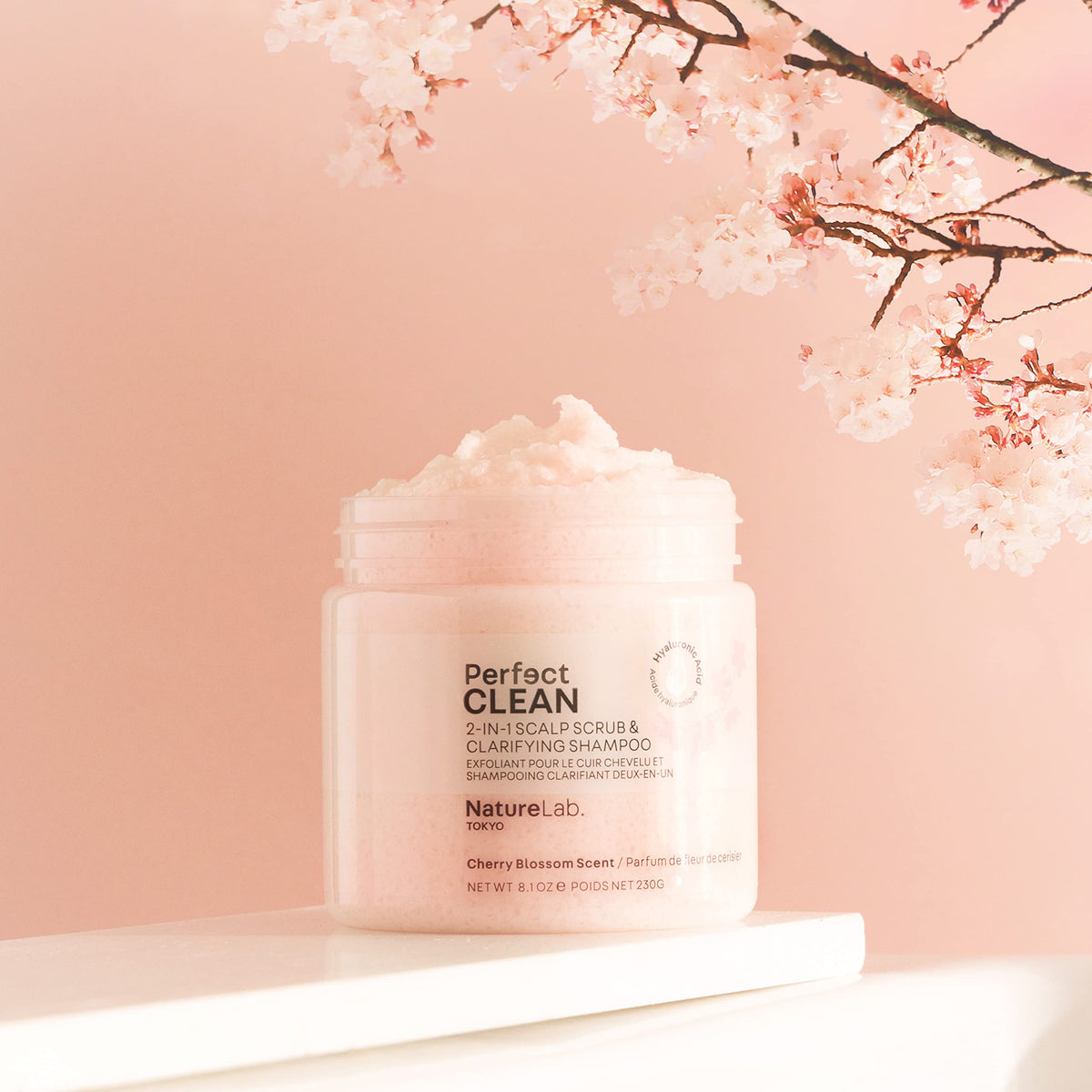 NatureLab.TOKYO bottle beside cherry blossoms evokes calming scent experience