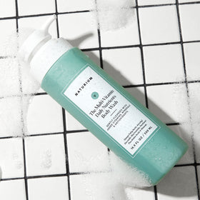 Naturium body wash lathered on arm showing gentle cleansing