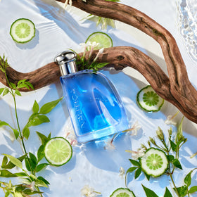 Side angle of Nautica Blue bottle reflecting light to show color and glass detail