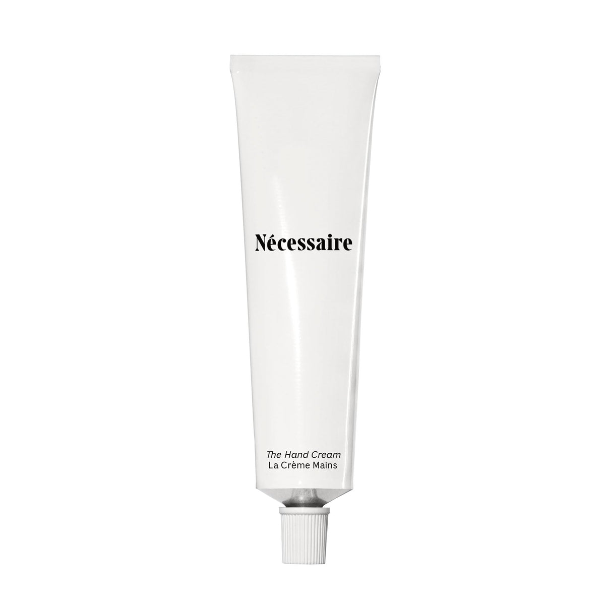 Nécessaire front tube view showing compact travel-ready packaging and benefits