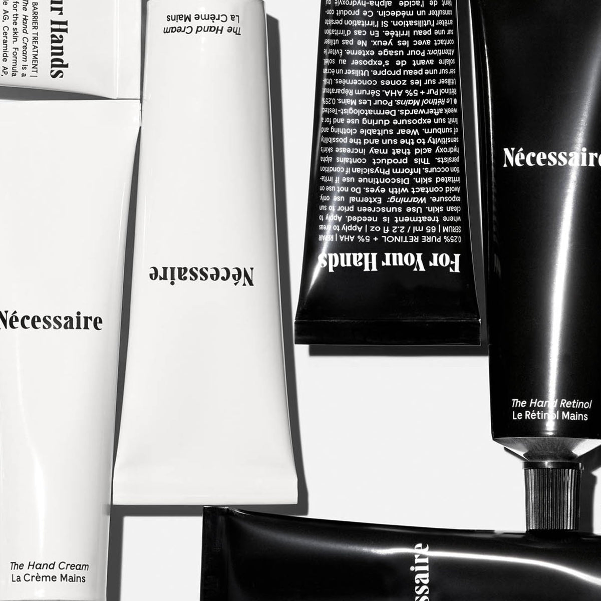 Nécessaire hand retinol balm open pot showing creamy repair texture